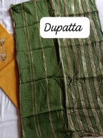 Mustard dress material paired with a vibrant green dupatta