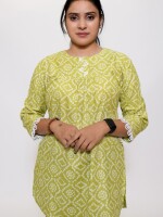 fresh green bandhani print top length loose fit short kurti with pleated shoulder yolk enhanced with lace