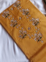 Mustard dress material paired with a vibrant green dupatta