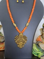 Orange glass beads necklace with oxidised golden Durga pendant and matching earrings