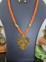 Orange glass beads necklace with oxidised golden Durga pendant and matching earrings