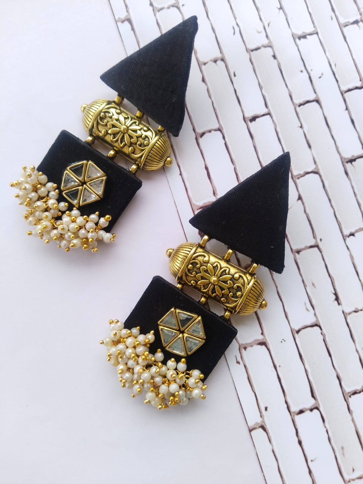 Black and gold triangular earrings