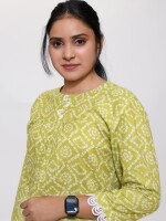 fresh green bandhani print top length loose fit short kurti with pleated shoulder yolk enhanced with lace