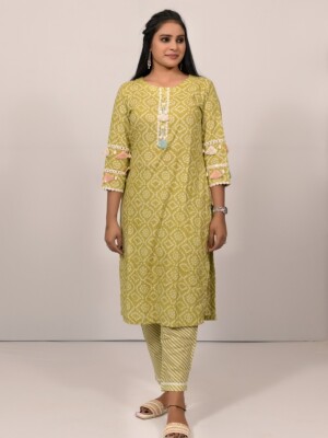 Straight-cut cotton Bandhej fresh green color kurti highlighted with Kaudi detailing and lace, paired with Leheriya cotton print pants