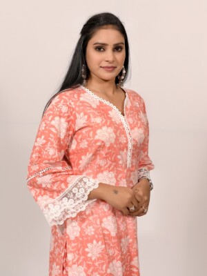 Straight-cut soft orange and white printed kurta highlighted with lace and pearls, paired with Leheriya cotton pants.