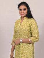 The fresh green cotton Bandhej straight-cut kurta set highlighted with sparkling diamond and lace on the neck, paired with Leheriya cotton print pants