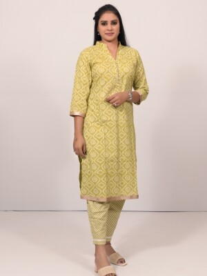 The fresh green cotton Bandhej straight-cut kurta set highlighted with sparkling diamond and lace on the neck, paired with Leheriya cotton print pants