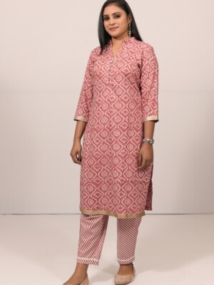 The onion pink cotton Bandhej straight-cut kurta set highlighted with sparkling diamond and lace on the neck, paired with Leheriya cotton print pants