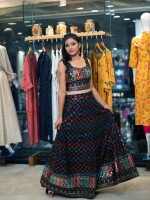 A classic cut lehenga crafted from a black georgette fabric base, adorned with beautiful multicolored thread and mirror all-over embroidery.