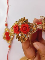 Elegant kundan pair rakhi set for bhai and bhabhi with mini nariyal, roli, and chawal