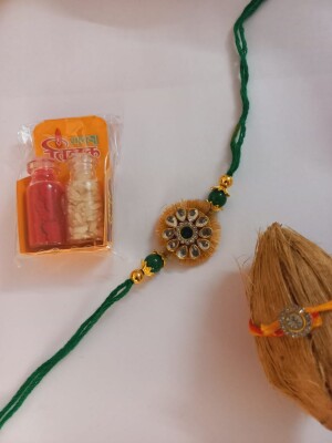 Elegant green color rakhi for brother with nariyal roli and chawal