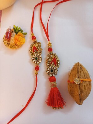 Red kundan rakhi set for bhai and Bhabhi complete with mini nariyal roli and chawal