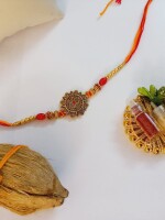 Beautiful golden rakhi for bhai with mini nariyal roli and chawal