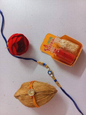 Blue evil eye rakhi for bhai with mini nariyal roli and chawal