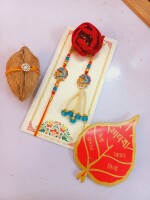 Gleaming blue and gold rakhi set for bhai and bhabhi