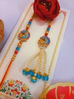 Gleaming blue and gold rakhi set for bhai and bhabhi