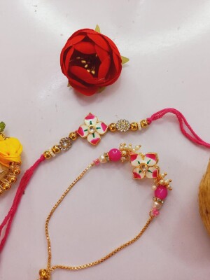 Graceful pink stone rakhi set for bhai and bhabhi