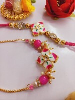 Graceful pink stone rakhi set for bhai and bhabhi